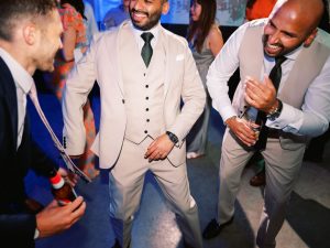 groom and friends dancing in light coloured suits